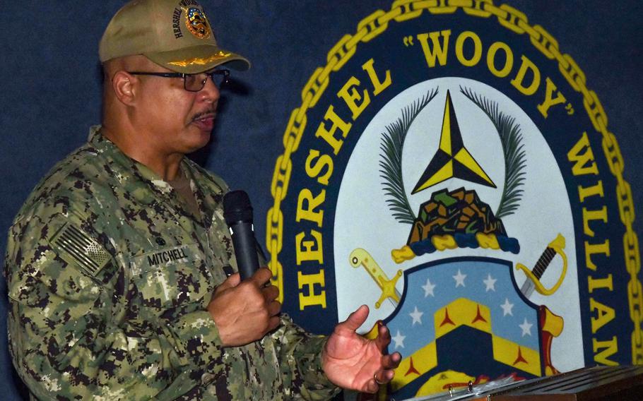 Capt. Lenard Mitchell, Gold crew commander of the expeditionary sea base USS Hershel “Woody” Williams, speaks during a change of command ceremony in the hangar bay while deployed to Namibia, Nov. 25, 2022. Mitchell was relieved of command in connection to the grounding of the ship off the coast of Gabon in May, the Navy announced Monday.