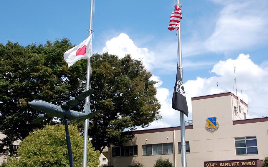 U.S and Japanese flags fly at half-staff outside the 374th Airlift Wing's headquarters at Yokota Air Base, Japan, Thursday, Aug. 15, 2024. 