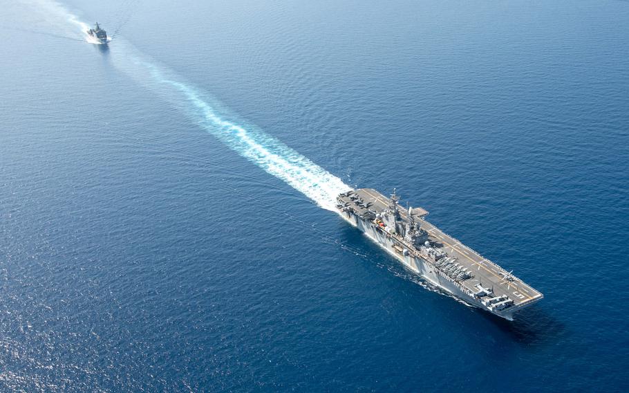 The amphibious assault ship USS Bataan and dock landing ship USS Carter Hall sail together in the Red Sea on Aug. 8, 2023. Components of the Bataan Amphibious Ready Group and the 26th Marine Expeditionary Unit are deployed to the U.S. 5th Fleet area of operations. 