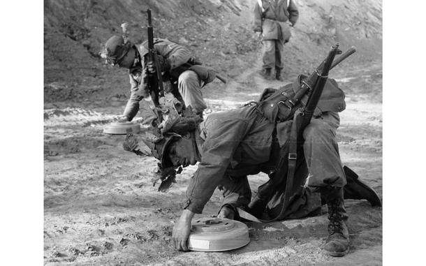 Somewhere in the mountains, South Korea, Jan. 5, 1962: Privates First Class Robert Andalis (front) and John Barnes of A Company, 2nd Battle Group, 12th Cavalry Regiment check and defuse landmines found on the road. 

The men of the 12th Cavalry Regiment participated in a month-long Army training test. The training, which began Jan. 2, is held in the mountain areas of South Korea where the cavalrymen honed their skills in varied terrains such as jungles and expansive open agricultural paddies. Part of the combat exercise was devoted to learning to spot and defuse so-called boobytraps - often hidden anti-personnel mines. 

Looking for Stars and Stripes’ historic coverage? Subscribe to Stars and Stripes’ historic newspaper archive! We have digitized our 1948-1999 European and Pacific editions, as well as several of our WWII editions and made them available online through https://starsandstripes.newspaperarchive.com/

META TAGS: 12th Cavalry Regiment; 1st Cavalry Division; U.S. Army; boobytrap; booby trap; IED; improvised explosive device; mine; anti-personnel mine