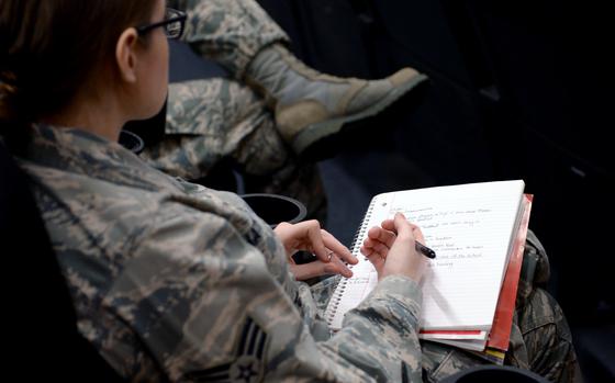 A U.S. Airman takes notes during a briefing on educational benefits given by a Veterans Affairs representative at the base theater at Spangdahlem Air Force Base, Germany, March 24, 2014. The briefing gave attendees more information on how to activate, use and transfer their educational benefits. (U.S. Air Force photo by Senior Airman Alexis Siekert/Released)