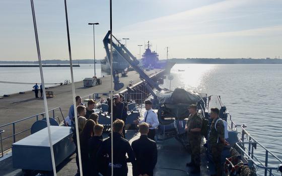 The crew of the minesweeper Dillingen greets participants of the German navy's "Marine Live" program in Kiel, Germany, on Aug. 27, 2024.                               