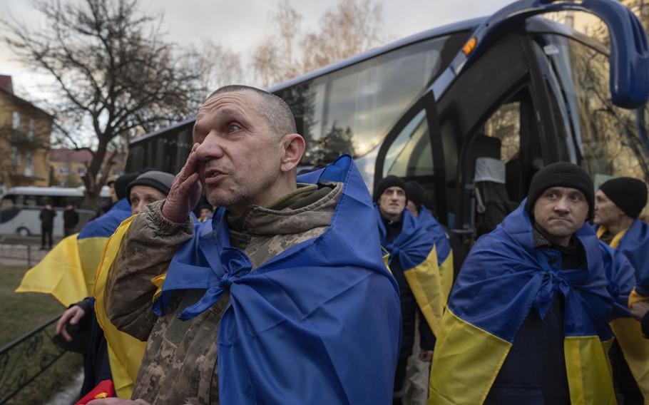 Ukrainian servicemen react after returning from captivity.