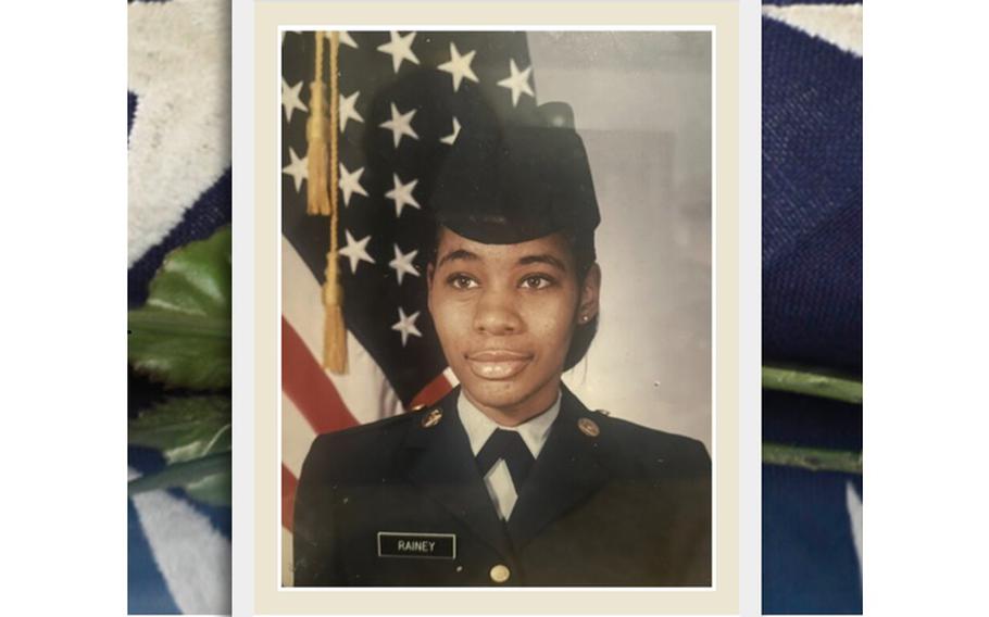 A portrait of a female Army soldier in dress uniform standing in front of a U.S. flag.