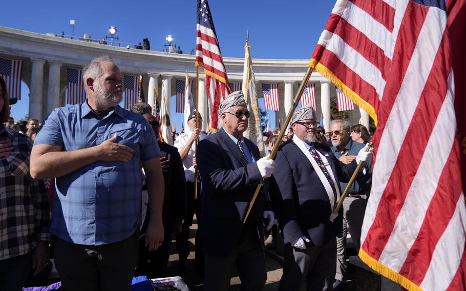 Attendees look on during the Presentation of the Colors at the National 