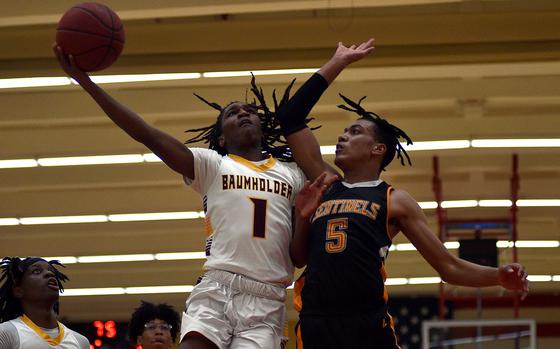 Baumholder's Leo Kirkland goes up for a layup while Spangdahlem's Caleb Jackson defends during a Dec. 13, 2024, game at the Hall of Champions in Baumholder, Germany.