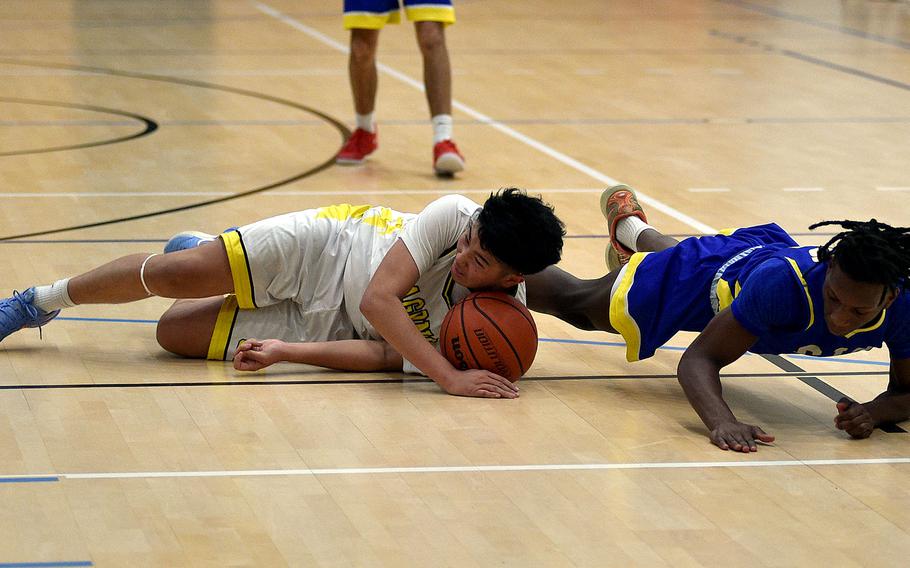 Kai Vickerstaff and Makari Spencer battle for the ball.