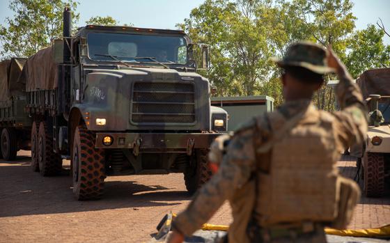 Lance Cpl. Brooke Adamassu, a motor vehicle operator with Combat Logistics Battalion 5 (Reinforced), Marine Rotational Force – Darwin, guides a 7-ton truck during the Predator’s Run exercise at Mount Bundey Training Area, Australia, July 15, 2024.


