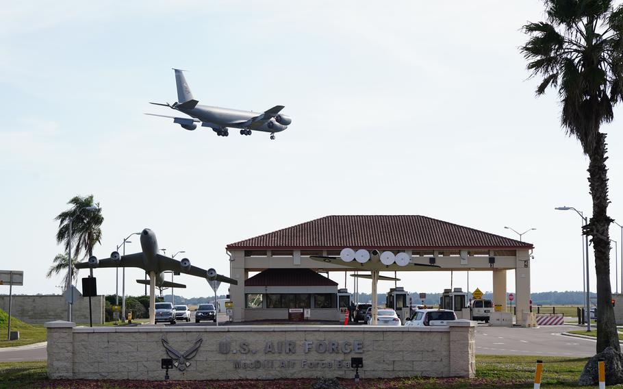 The plane flies over the entrance gate to the base.