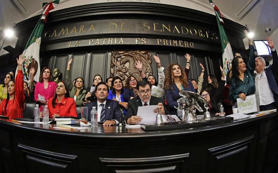 Ruling Morena Party senator Gerardo Fernandez Norona, center, and members of Mexico's Senate celebrate after they passed the controversial judicial reform at the Senate's chamber in Mexico City on Sept. 11, 2024. Mexico became the world's first country to allow voters to elect judges at all levels on Wednesday, after protesters invaded the upper house and suspended debate on the issue. (Cesar Sanchez/AFP/Getty Images/TNS)