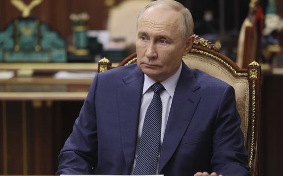 Russian President Vladimir Putin listens to the CEO of the Russian Direct Investment Fund Kirill Dmitriev during their meeting at the Kremlin in Moscow, Russia, Monday, Jan. 13, 2025. (Alexander Kazakov, Sputnik, Kremlin Pool Photo via AP)