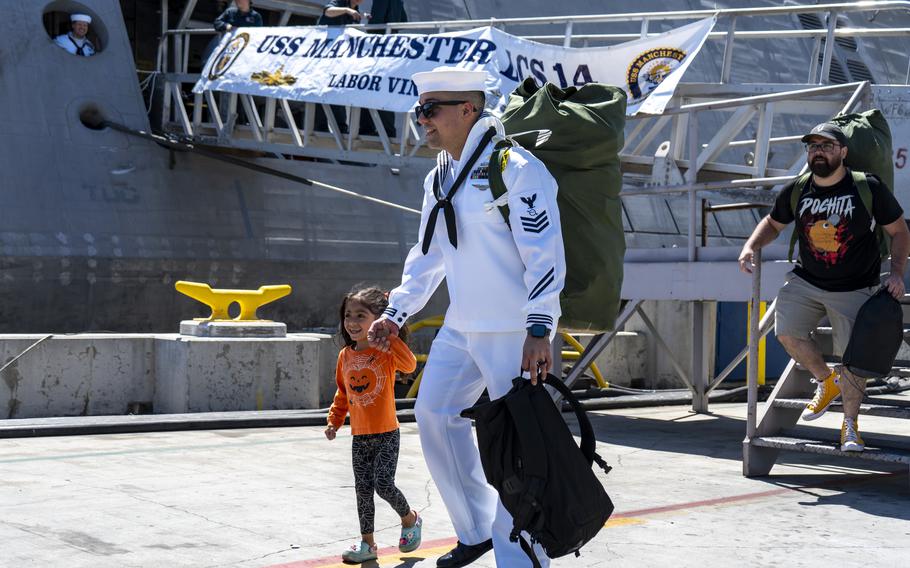 Operations Specialist 1st Class Dominick Torres  greets a loved one