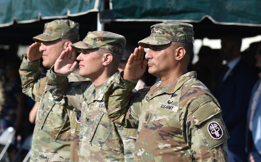 Command Sgt. Maj. Jorge Oquendo, from right , Col. Ted Brown, Landstuhl Regional Medical Center commander, and retiring Command Sgt. Maj. Omar Mascarenas salute during a change-of-responsibility ceremony for the hospital’s senior enlisted leader at LRMC on Thursday.