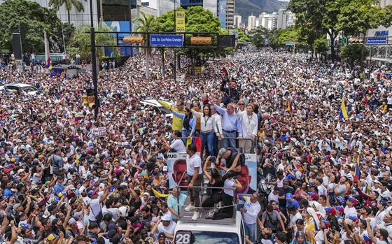 Venezuelan opposition leader Maria Corina Machado and opposition candidate Edmundo Gonzalez ride atop a truck during a protest in Caracas on July 30, 2024.