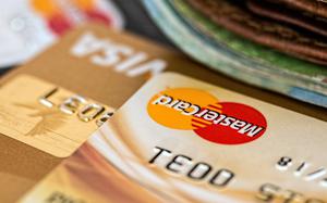 MasterCard and Visa credit cards sit on a table.