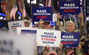 Attendees hold signs reading "mass deportations now!" during the third day of the 2024 Republican National Convention at the Fiserv Forum in Milwaukee, Wisconsin, on July 17, 2024. (Patrick T. Fallon/AFP/Getty Images/TNS)