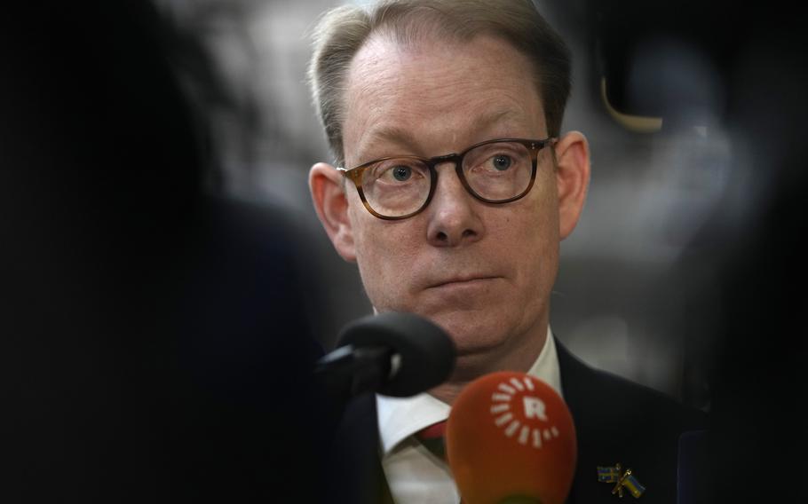 Sweden’s Foreign Minister Tobias Billström speaks with the media as he arrives for a meeting of EU foreign ministers at the European Council building in Brussels