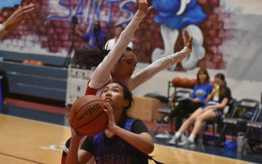 Jeanice DeSilva is fouled while shooting.