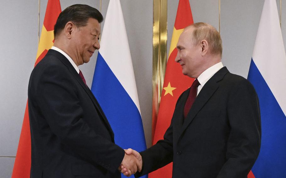 Russian President Vladimir Putin, right, and Chinese President Xi Jinping shake hands during their meeting on the sidelines of the Shanghai Cooperation Organisation (SCO) summit in Astana, Kazakhstan, July 3, 2024. 