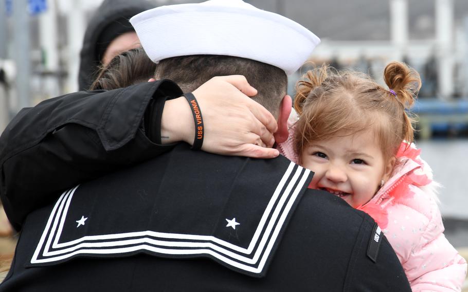 A sailor embraces his loved one