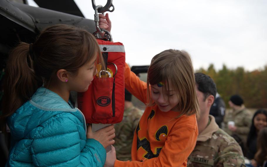 Grafenwoehr Elementary School students hang out on a Black Hawk helicopter.