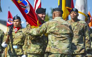 Maj. Gen. John Rafferty receives the unit colors from Gen. Darryl Williams as he takes command of the 56th Artillery Command during a ceremony on June 13, 2024, in Wiesbaden, Germany.