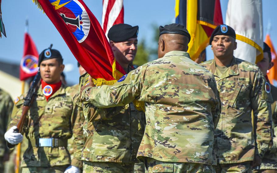 Maj. Gen. John Rafferty receives the unit colors from Gen. Darryl Williams as he takes command of the 56th Artillery Command during a ceremony on June 13, 2024, in Wiesbaden, Germany.