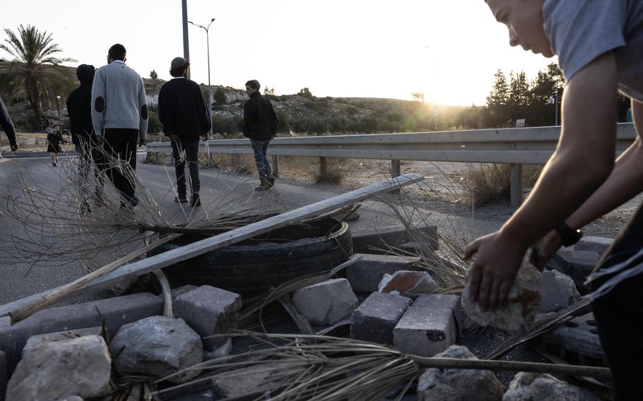 Groups of right-wing and settler youth build a makeshift blockade using rocks, tires and bricks to prevent aid trucks from leaving the West Bank. 