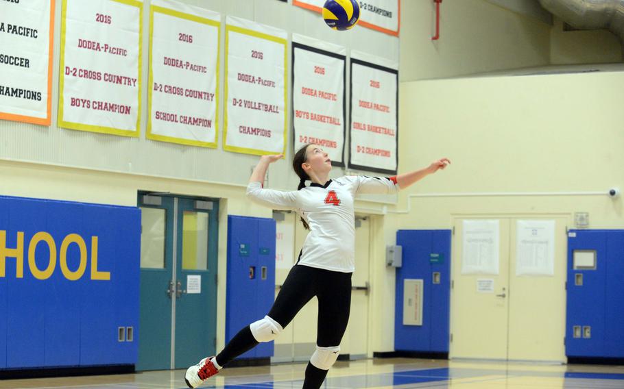 Julia Hunt serves the ball.