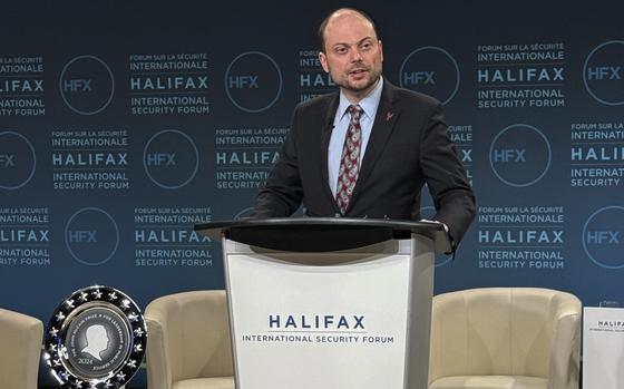 A Russian dissident speaks at a podium that reads “Halifax International Security Forum.”