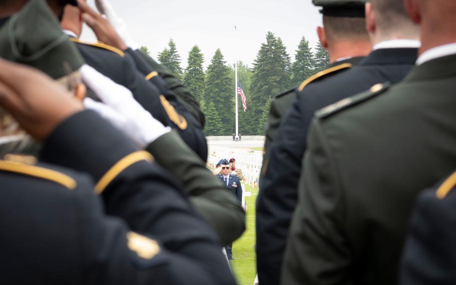 Troops salute the flag during a Memorial Day ceremony at Ardennes American Cemetery in Neupré, Belgium, on May 25, 2024. 