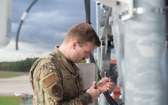 Airman 1st Class Wesley Hodgman, a cyber infrastructure Airman with the 157th Communications Flight, installs a new WiFi Access Point Oct. 18, 2022 at Pease Air National Guard Base, New Hampshire. Infrastructure Airmen maintain and manage all network technologies to ensure extended network access across the entire installation. (U.S. Air National Guard photo by Staff Sgt. Victoria Nelson)