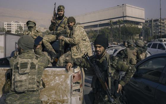 Militants celebrate the fall of the Assad regime in central Damascus on Dec. 9. (MUST CREDIT: Lorenzo Tugnoli for The Washington Post)