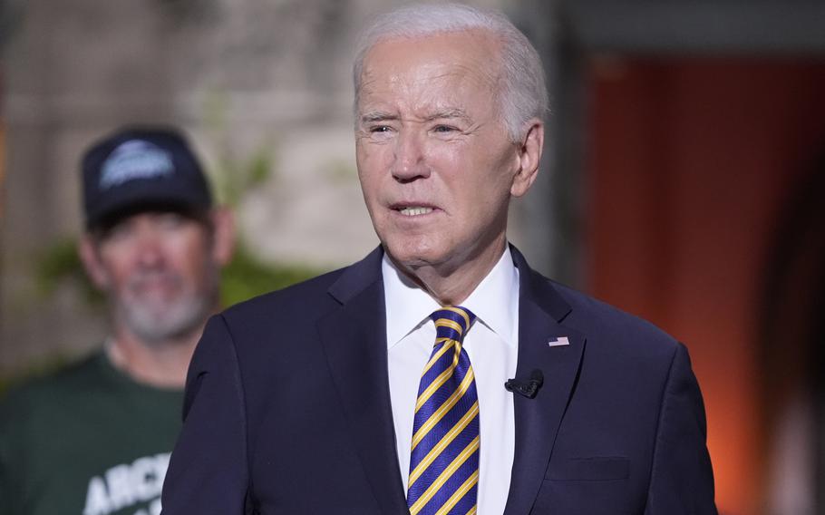 President Joe Biden's speaks with football players at Archmere Academy in Claymont, Del., Friday, Sept. 20, 2024, during a walkthrough visit ahead of his meetings with world leaders there on Saturday. (AP Photo/Mark Schiefelbein)