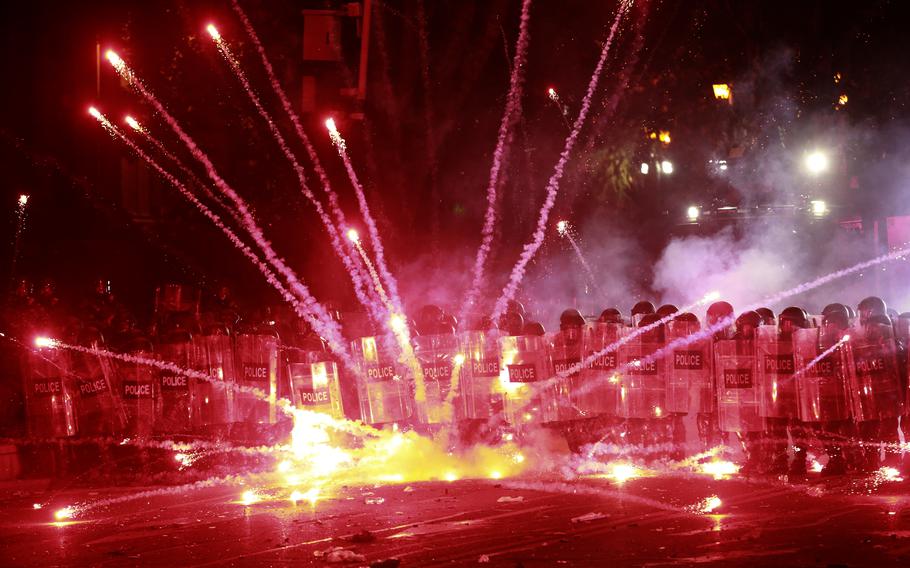 Fireworks scream into the sky during a protest in Tbilisi, Georgia.