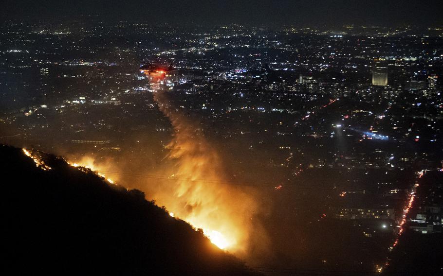 Water is dropped by helicopter on the burning Sunset Fire in Hollywood Hills 