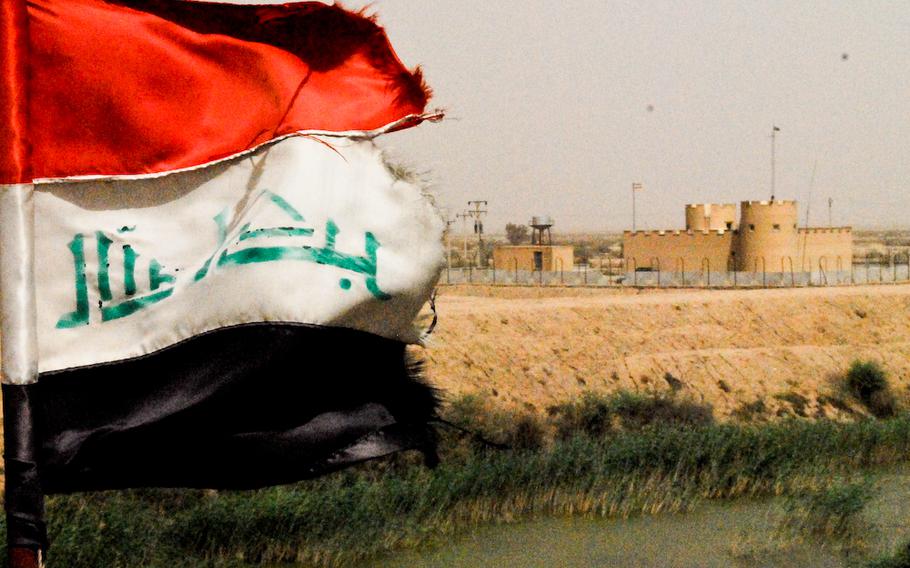 An Iranian flag waves at the border between Iraq and Iran.