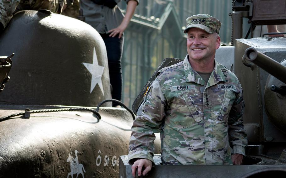 Gen. Christopher Cavoli rides in an M5 Stuart during the Tanks in Town celebration in Mons, Belgium.