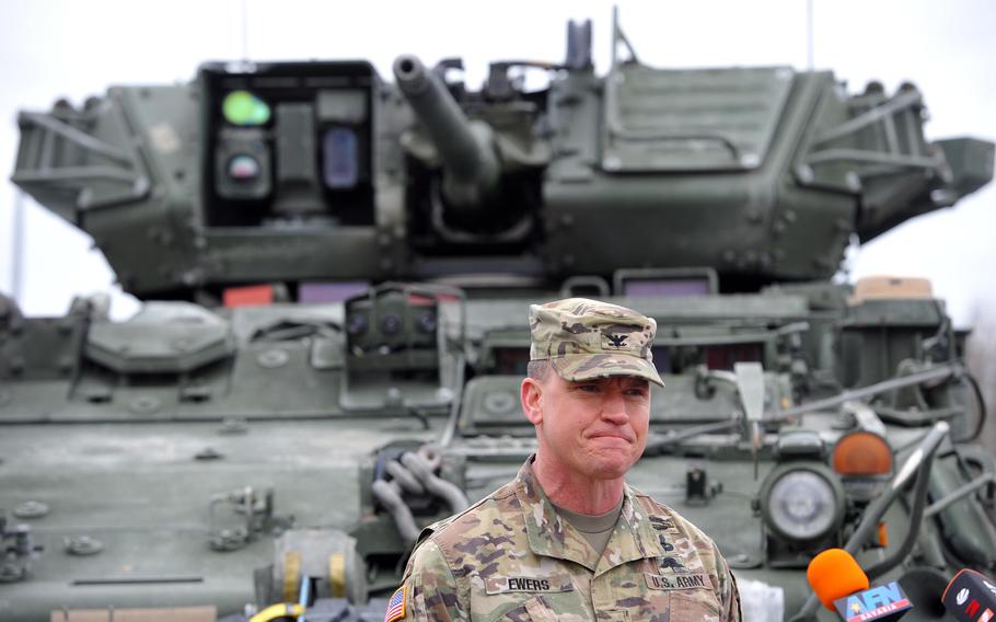 Col. Joe Ewers, commander of the 2nd Calvary Regiment talks to the media at Vilseck Army Airfield, Germany, as his troops prepare to deploy to Romania, Feb. 9, 2022. About 1,000 soldiers are being sent to Romania to reassure allies worried about Russia. 