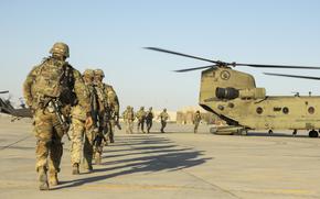 Georgia Army National Guard soldiers enter a CH-47 Chinook helicopter during a training mission in western Iraq on Oct. 30, 2024. They are part of a coalition to prevent a resurgence of the Islamic State group in Iraq and Syria. U.S. forces have repeatedly come under attack by militants in the two countries over the past year.