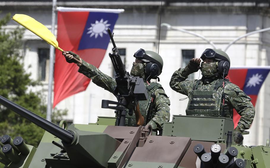 Taiwanese soldiers salute during National Day celebrations in front of the Presidential Building in Taipei, Taiwan, on Oct. 10, 2021.