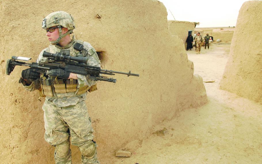 Sgt. Joseph Prince, a soldier from 3rd Platoon, Company A, Task Force 3-66 Armor, pulls security while Iraqi soldiers search a house Feb 19 in Tahweela, Iraq. 