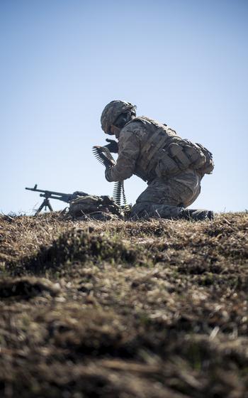 A cadet collects machine gun rounds