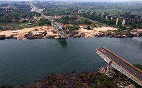 The Juscelino Kubitschek Bridge is collapsed into the Tocantins River in Estreito, Maranhao state, Brazil, Tuesday, Dec 24, 2024. Several cars and trucks crossing the bridge when it collapsed on Dec. 22 fell into the river, killing nine people and others are still missing. (AP Photo/Marinho Drones)