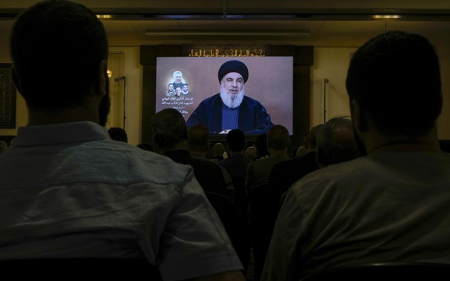 Hezbollah supporters watch a speech given by Hezbollah leader Sayyed Hassan Nasrallah on a screen during a ceremony to commemorate the death of senior Hezbollah commander Taleb Sami Abdullah, 55, who was killed last week by an Israeli strike in south Lebanon, in the southern Beirut suburb of Dahiyeh, Lebanon, Wednesday, June 19, 2024. 