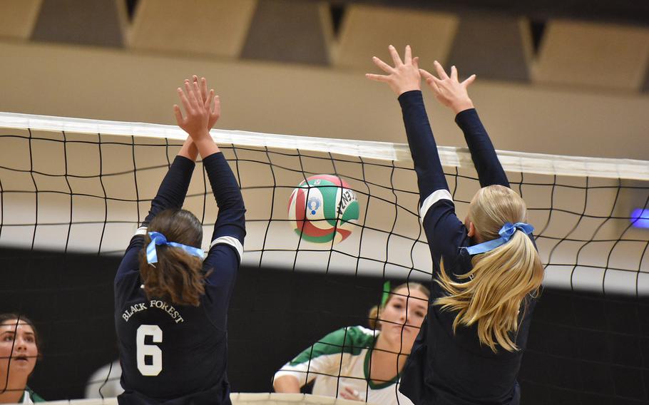 Naples' Emma Heavey can't get the ball over the net past the Black Forest Academy defense of Hanna Kooiman, left, and Priscilla Sivonen on Friday, Sept. 13, 2024, in Vicenza, Italy.