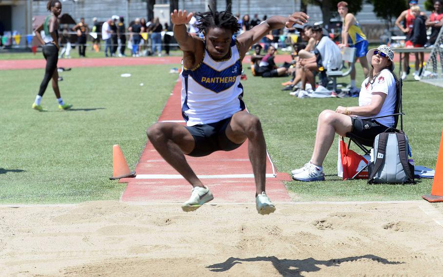 Guam High's Aaron Johnson descends toward the end of his Far East meet-record long jump of 6.75 meters.