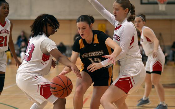 Stuttgart's Hannah Holmes tries to dribble through Kaiserslautern's Shayla King, left, and Olivia Illka during a Jan. 18, 2025, game at Stuttgart High School in Böblingen, Germany.