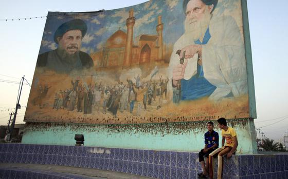 A large mural of Mohammad Baqir al-Sadr and Mohammad Sadiq al-Sadr.