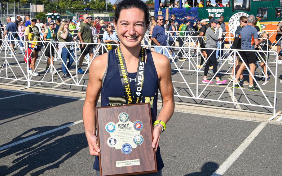 Elizabeth Sullivan is presented with the award for winning the Women’s 40th Annual Army Ten-Miler